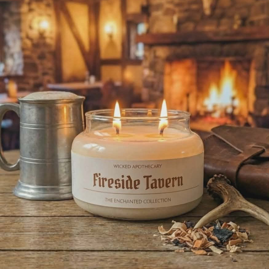 Candle labeled 'Fireside Tavern' with a mug and antlers on a wooden surface, fireplace in the background