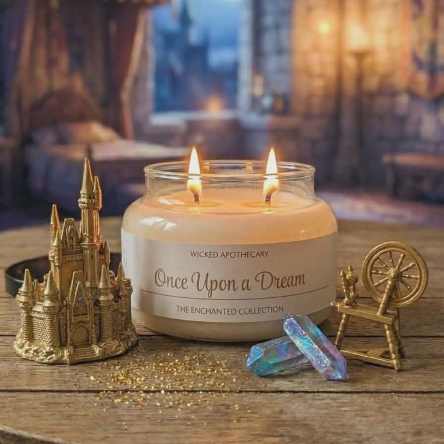 Candle labeled 'Once Upon a Dream' on a wooden table with decorative items in a cozy room setting.