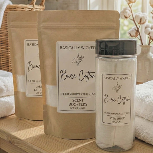 Bathroom products including a bottle and packaging labeled 'Basically Wicked Bare Cotton' on a wooden surface.