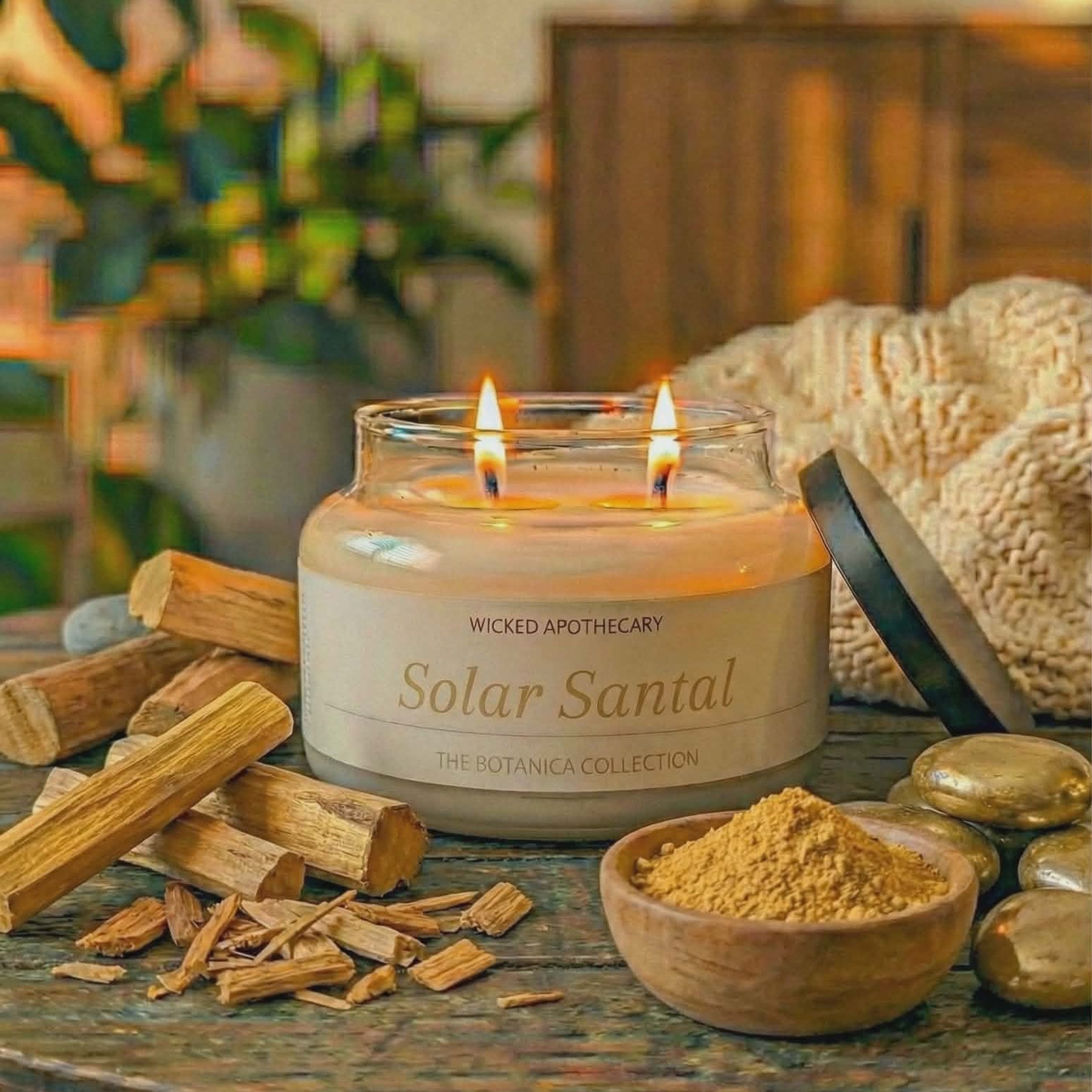 Wicked Apothecary Solar Santal candle on a wooden table with incense sticks and a bowl of sandalwood.