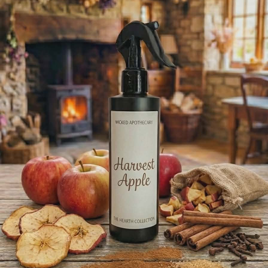 Harvest Apple spray bottle on a wooden table with apples and spices in a cozy room.