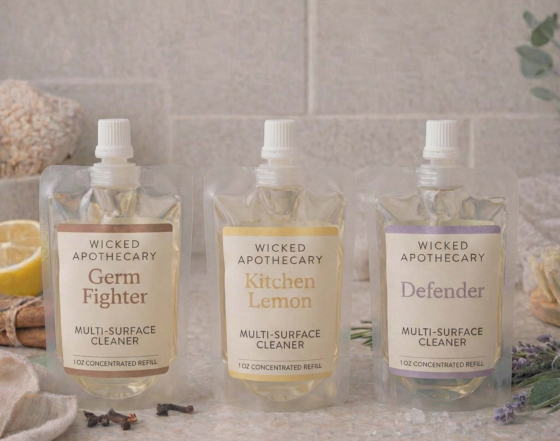 Three bottles of Wicked Apothecary multi-surface cleaners on a bathroom counter.