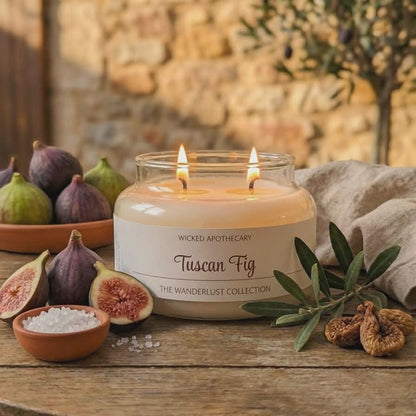 Wicked Apothecary Tuscan Fig candle on a wooden table with figs and olive branches.
