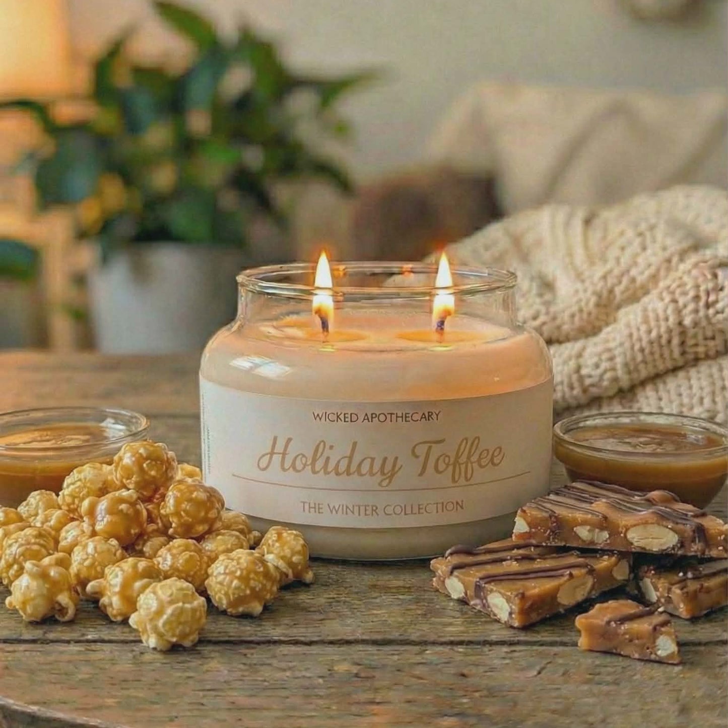 Wicked Apothecary Holiday Toffee candle on a table with popcorn and toffee, cozy indoor setting.