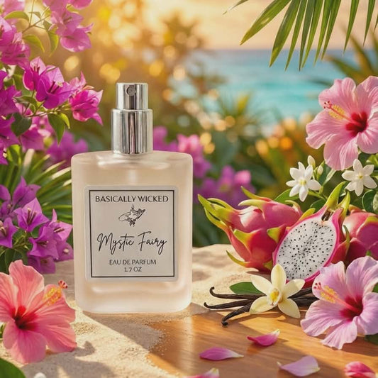 Perfume bottle labeled 'Basically Wicked' surrounded by tropical flowers and leaves with a blurred beach background.