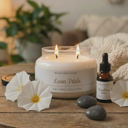Wicked Apothecary candle with flowers and rocks on a wooden table