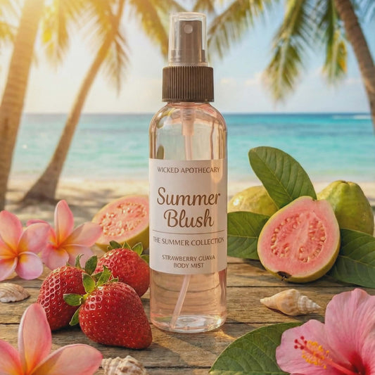 Bottle of 'Summer Blush' body mist with tropical fruits and flowers on a wooden surface.