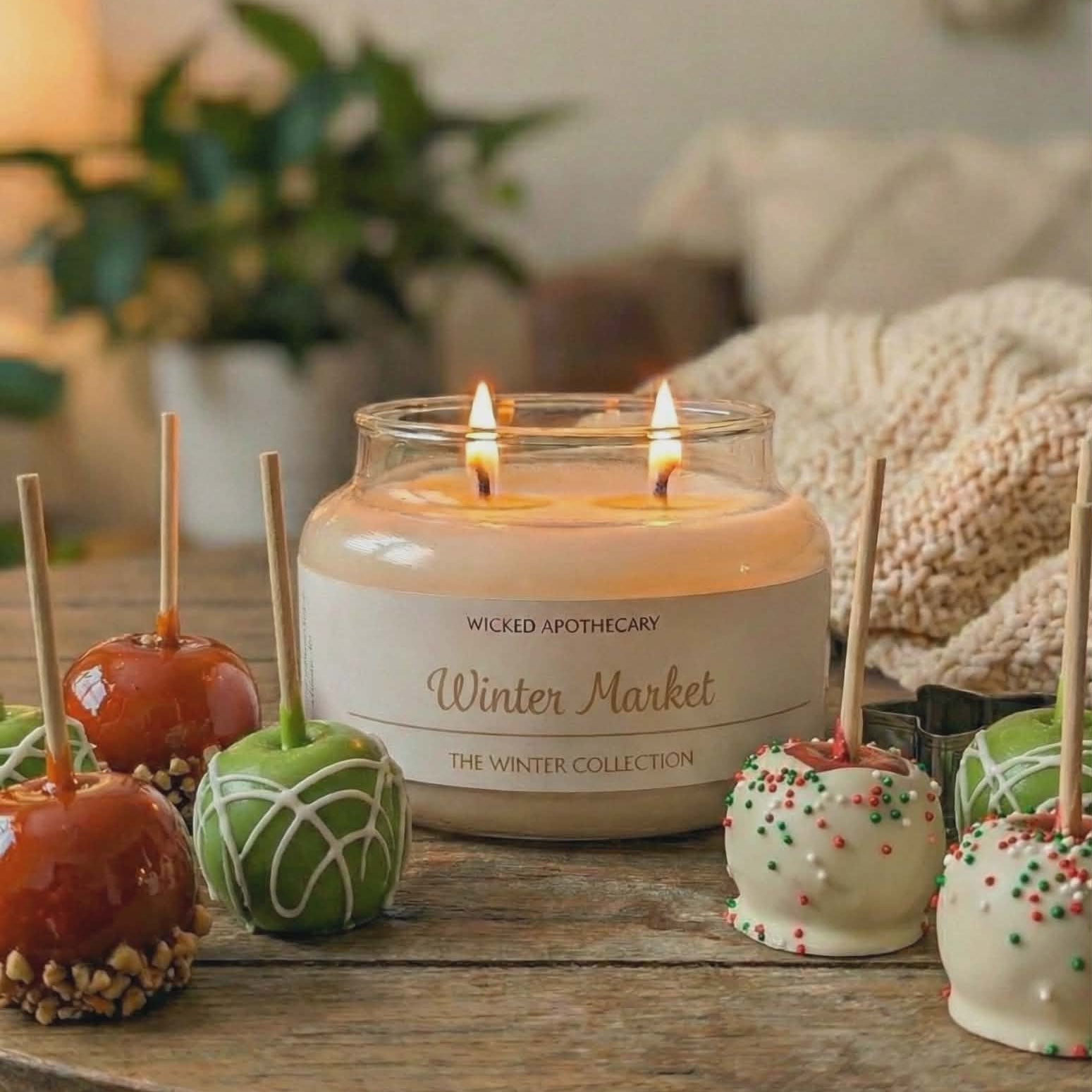 Wickless Candles Winter Market collection candle on a table with decorative apples and cake pops.