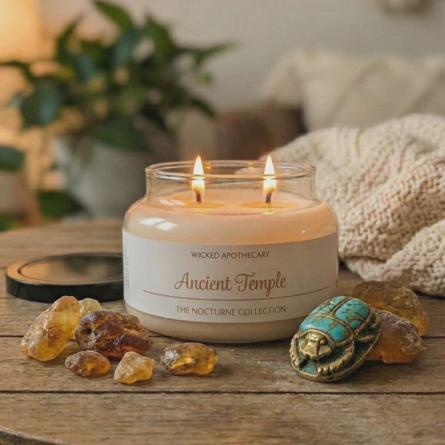 Wicked Apothecary candle on a wooden table with decorative elements