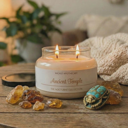 Wicked Apothecary candle on a wooden table with decorative elements