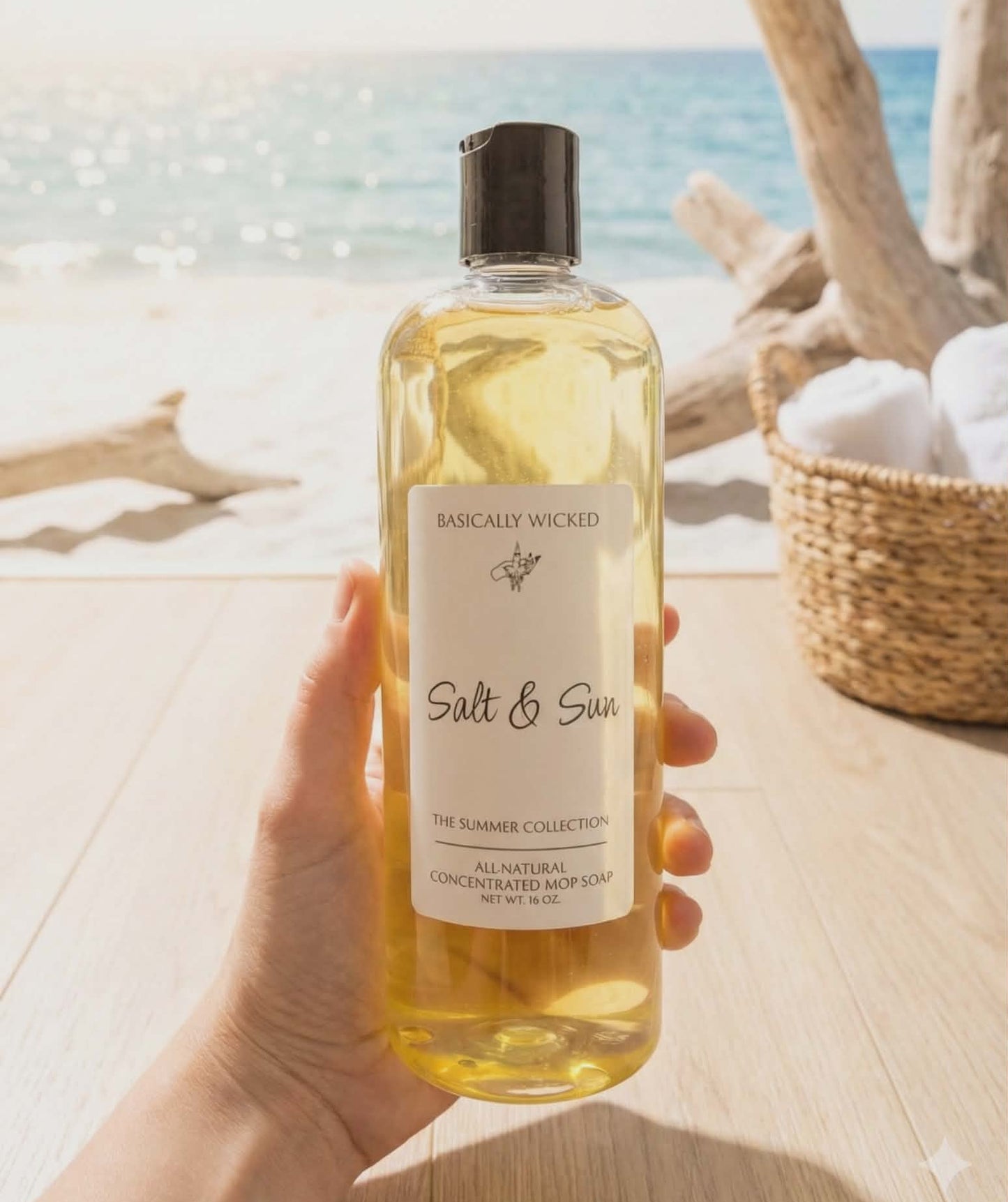 Hand holding a bottle of 'Salt & Sun' product with a beach background