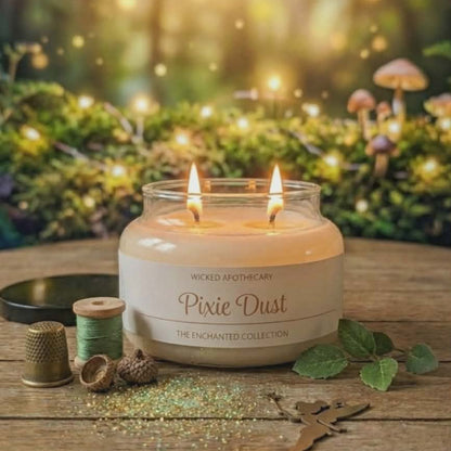 Candle labeled 'Pixie Dust' on a wooden surface with a forest background