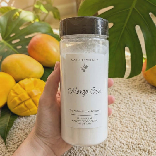 Hand holding a product labeled 'Mango Cove' with mangoes and leaves in the background