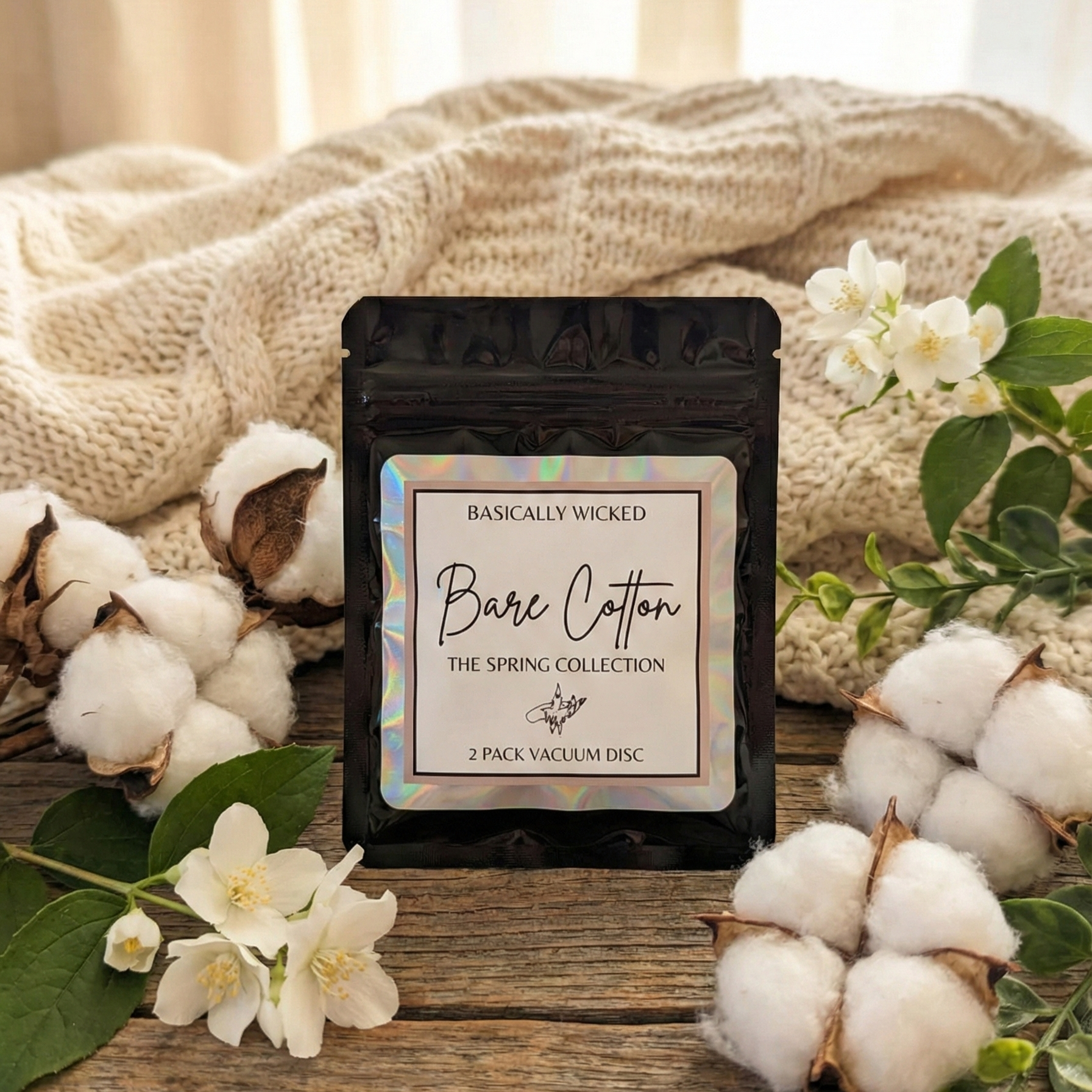 Packaged product labeled 'Bare Cotton' surrounded by cotton flowers and leaves on a wooden surface.