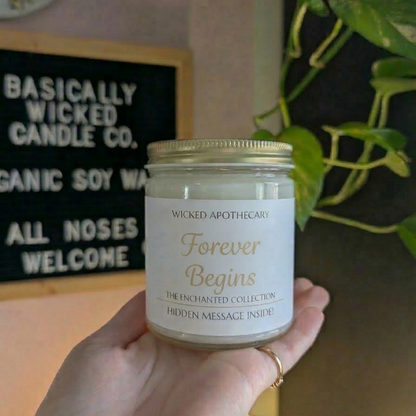 Hand holding a candle labeled 'Forever Begins' with a decorative background.