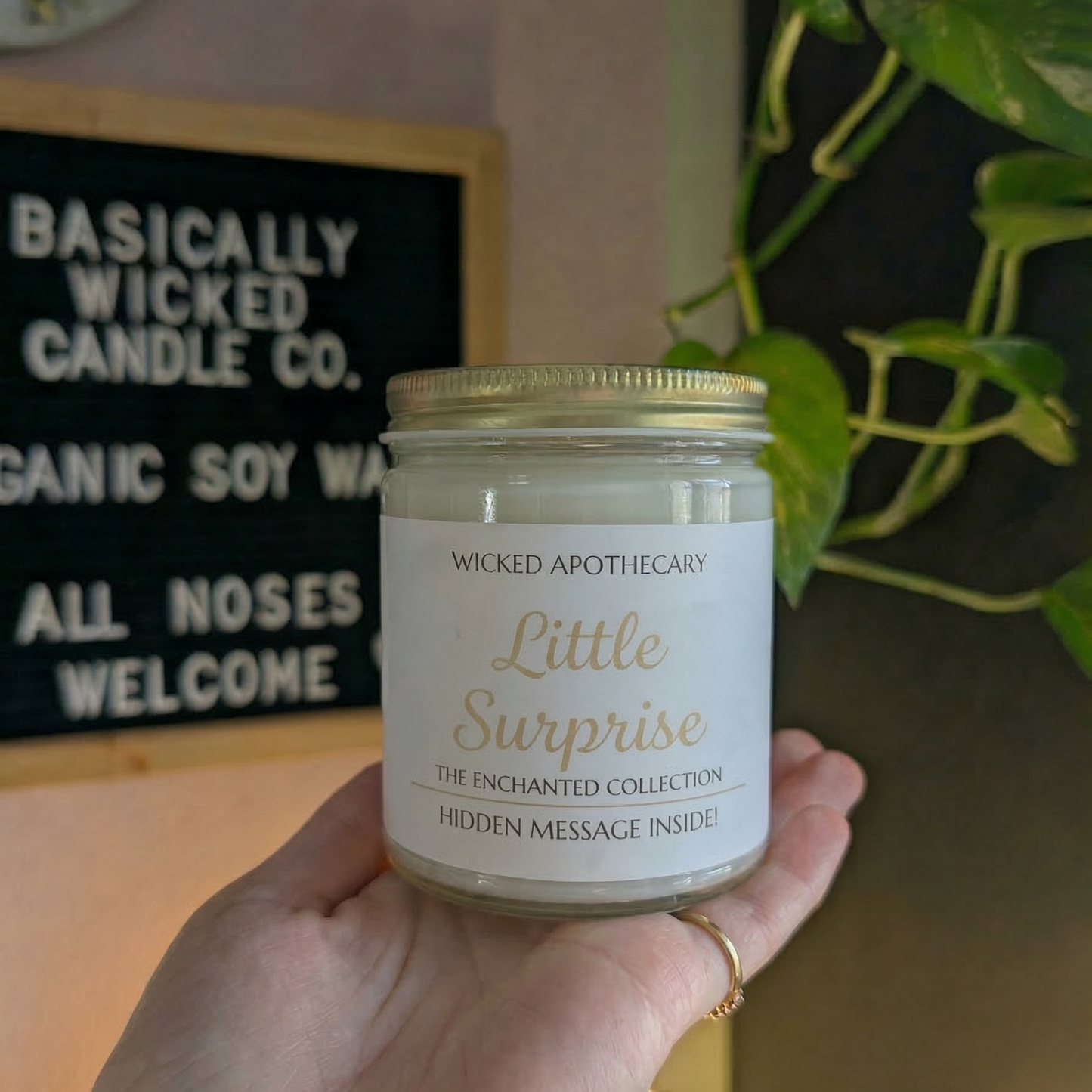 Hand holding a candle labeled 'Forever Begins' with a decorative background.
