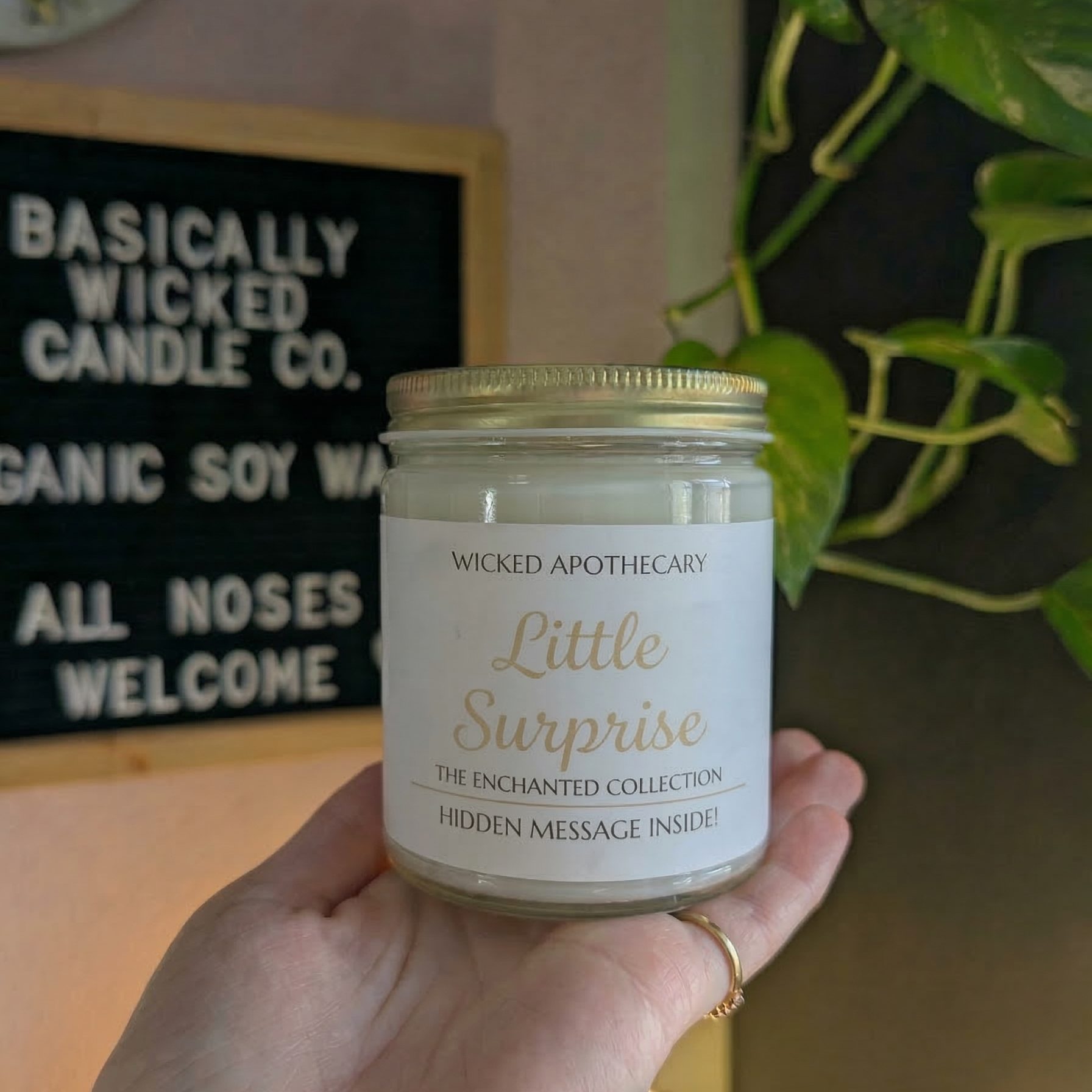 Hand holding a candle labeled 'Forever Begins' with a decorative background.