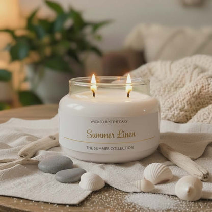 Wicked Apothecary Summer Linen candle on a table with decorative elements