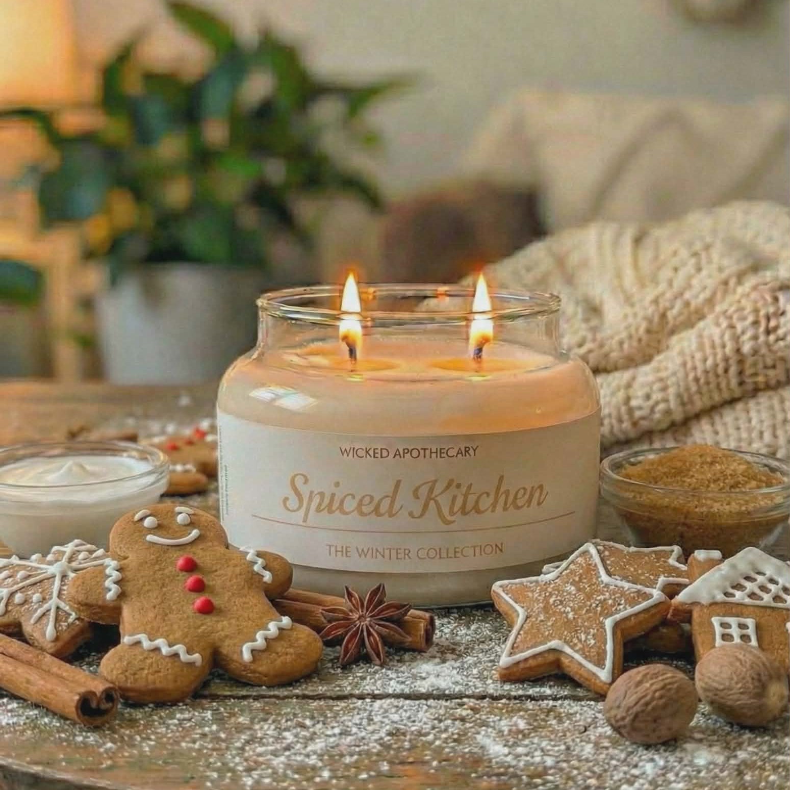 Spiced Kitchen candle on a wooden table with gingerbread cookies and spices