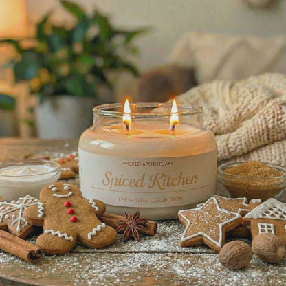 Spiced Kitchen candle on a wooden table with gingerbread cookies and spices