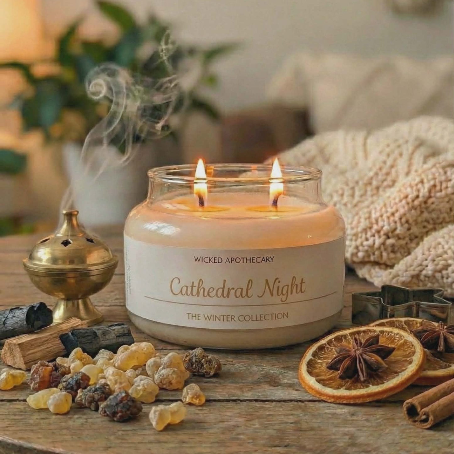 Candle labeled 'Cathedral Night' from Wicked Apothecary on a wooden table with decorative items.