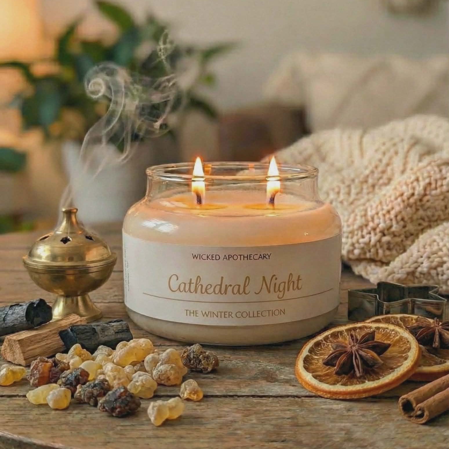 Candle labeled 'Cathedral Night' from Wicked Apothecary on a wooden table with decorative items.